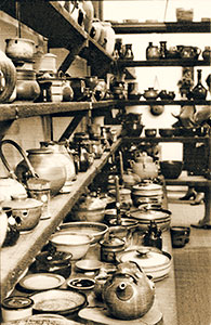 Shelves of pottery displayed in Potters Cottage showroom