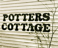 Potters Cottage - sign on wall of gallery