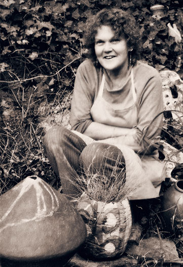 Sylvia Halpern, Potter, Warrandyte with her pots in garden in Warrandyte